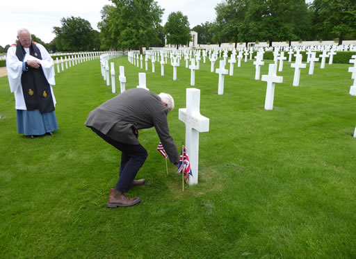 Mike Garrod places tribute at Paul DeBrular's grave